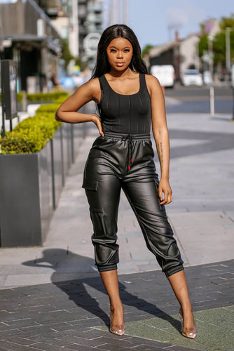 Our Black Faux Leather Cargo Pants with stylish side pockets, elastic waistband and adjustable strings. Perfect for a fashion-forward look that is both comfortable and durable